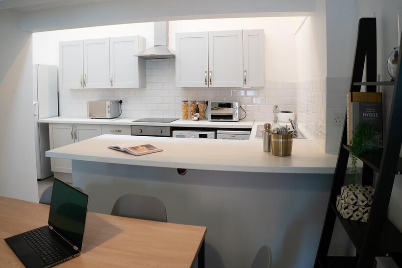 A bright and modern kitchen featuring ample sto...