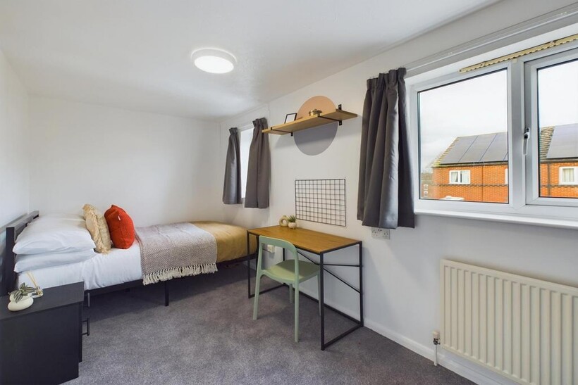 A bright and inviting double bedroom featuring ...