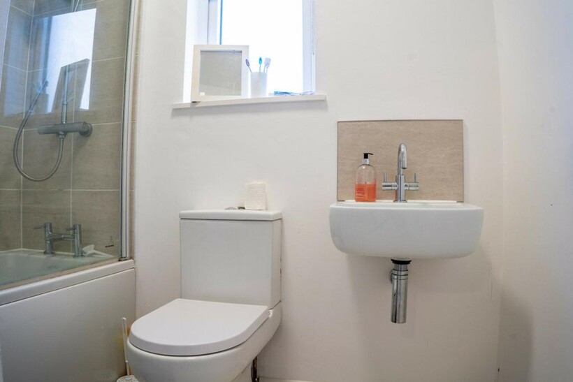 A clean and modern bathroom featuring a stylish...