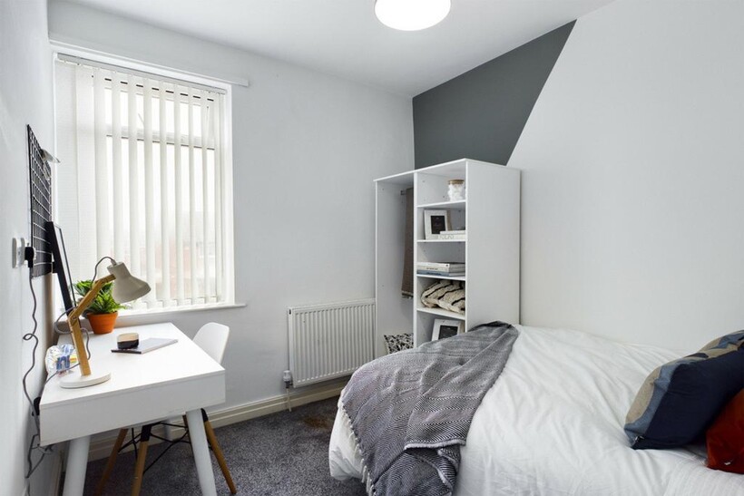 A bright and tidy double bedroom, featuring a s...