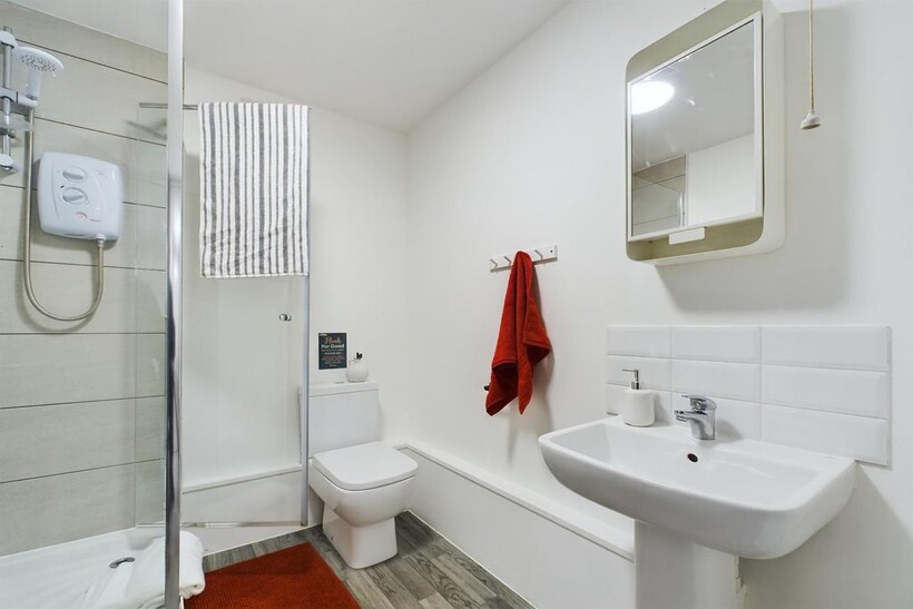 A bright and modern bathroom featuring a spacio...