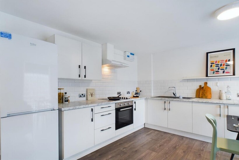 A bright and modern kitchenette, featuring slee...