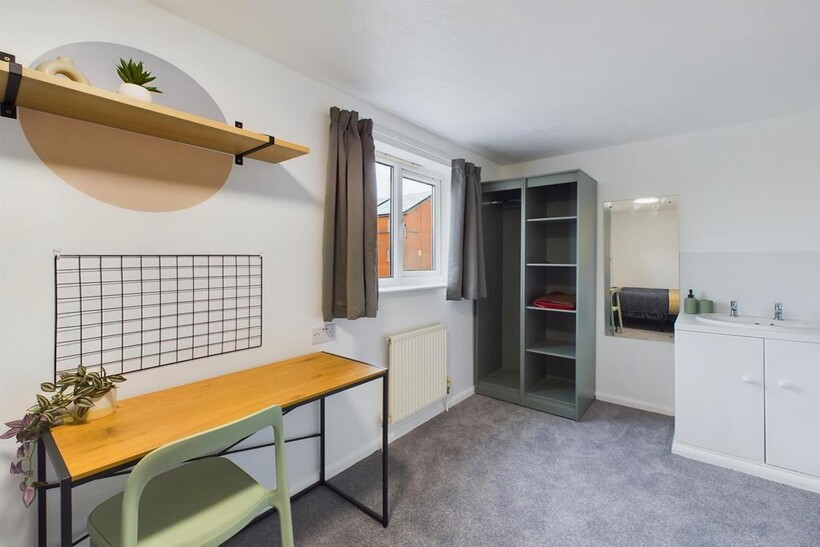 A well-lit and tidy double bedroom featuring a ...