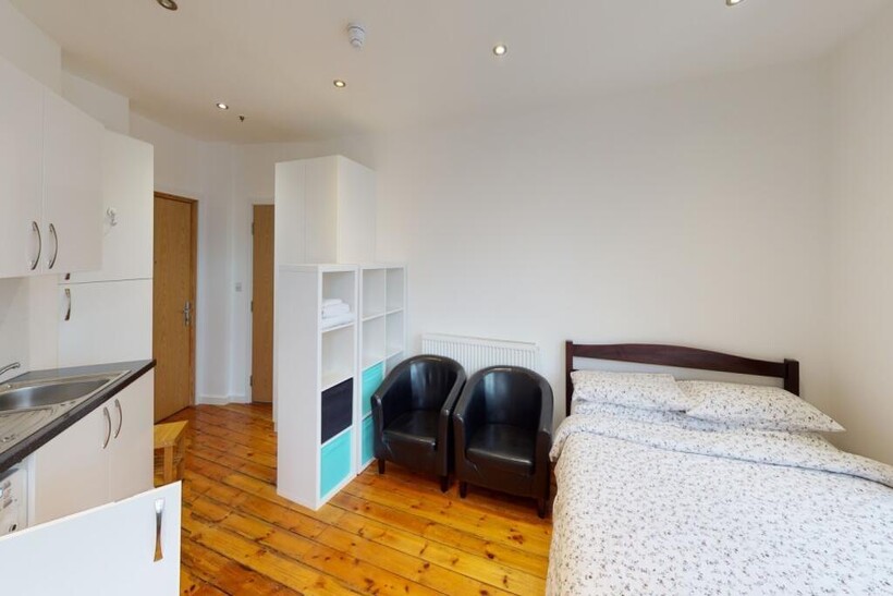 A bright and tidy single bedroom featuring a co...