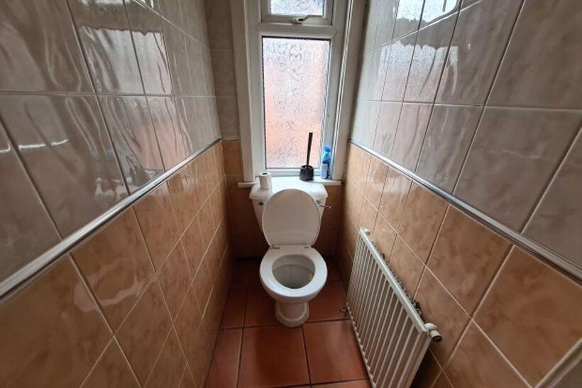 A clean and well-maintained single toilet room ...