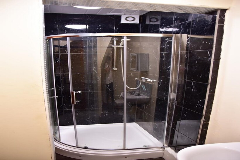 Modern bathroom featuring a sleek enclosed show...