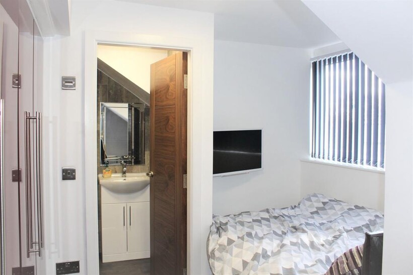 Bright and inviting bedroom featuring a large w...