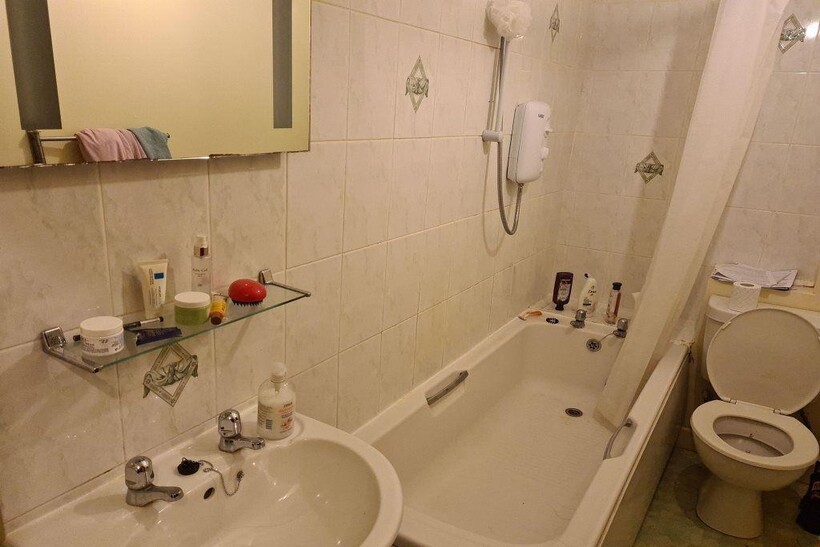 A clean and practical bathroom featuring a bath...