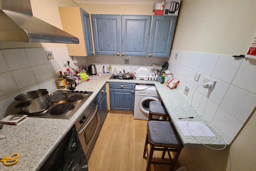 A compact and functional kitchen featuring mode...