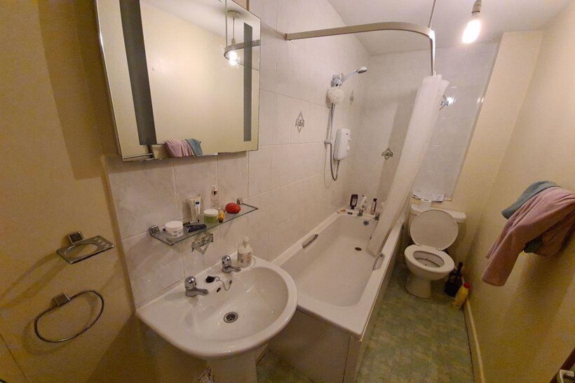 A neat and functional bathroom suite featuring ...
