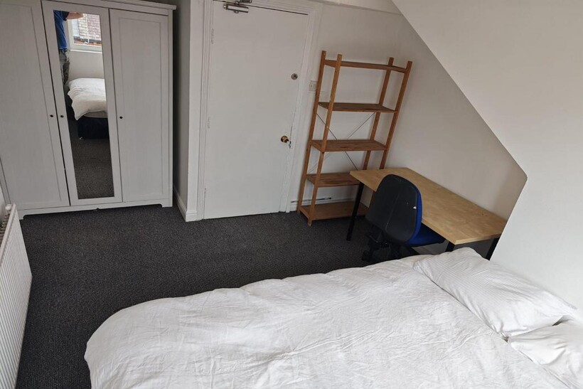 A clean and tidy bedroom space featuring a simp...