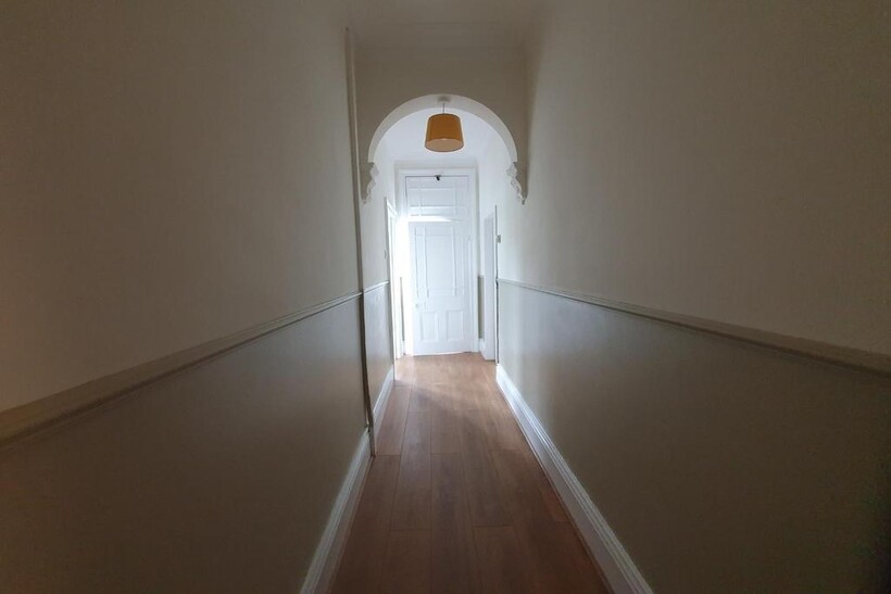 A clean and simple hallway with wooden flooring...
