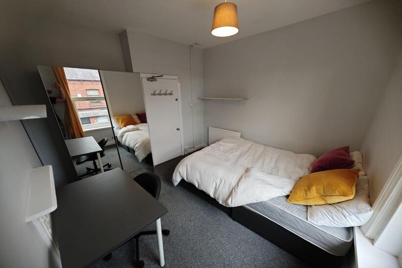 Cozy single bedroom featuring a comfortable bed...