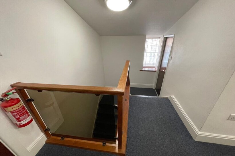 A clean and well-maintained staircase area feat...