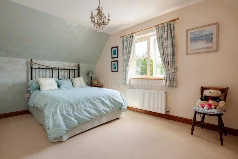 A bright and inviting master bedroom featuring ...