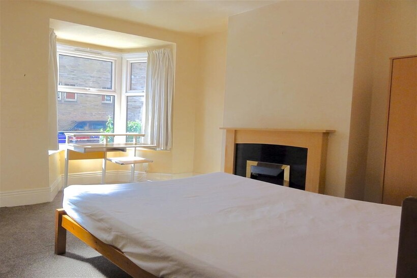 Bright and welcoming bedroom featuring a comfor...