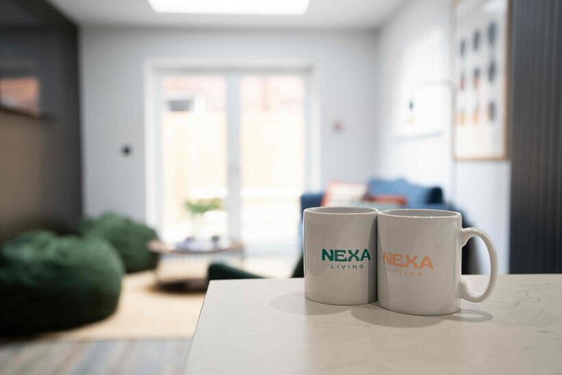 Bright and modern living room with ample natura...