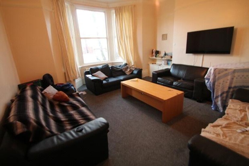 A well-lit, inviting living room featuring comf...