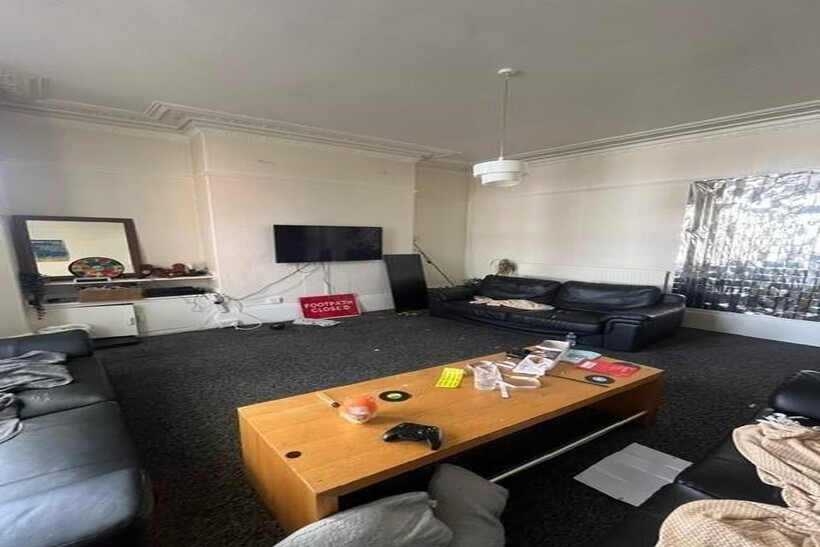 A comfortable living room featuring a large sof...