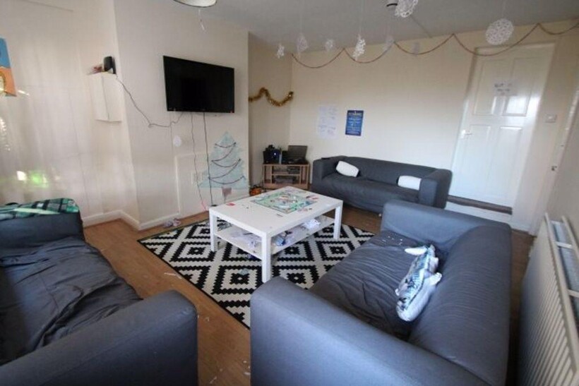 A spacious and well-lit living room featuring c...