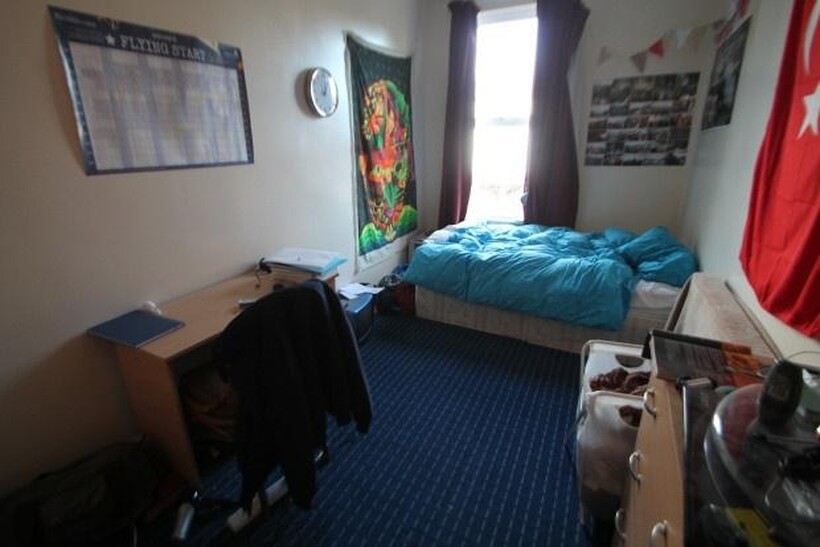 A spacious and well-lit bedroom featuring a com...