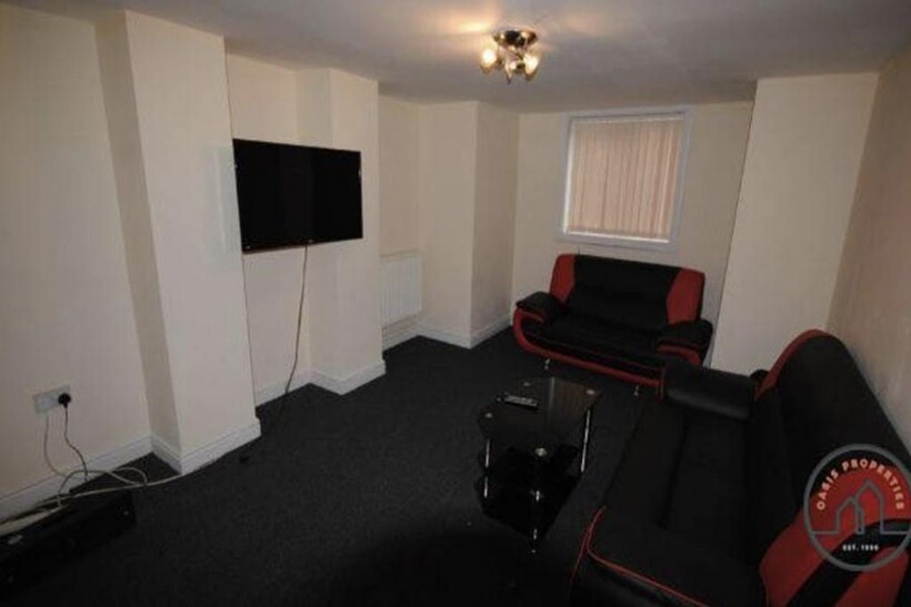 A modern, well-lit living room featuring comfor...