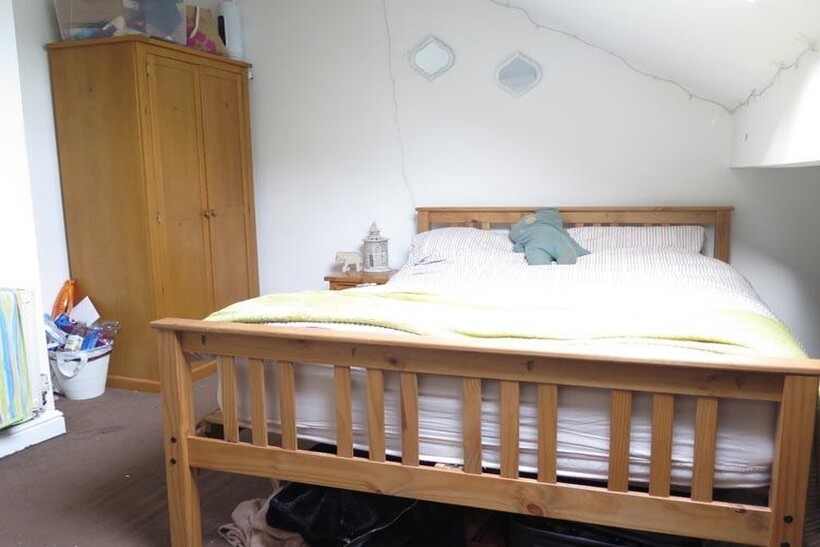 A spacious master bedroom featuring a large com...