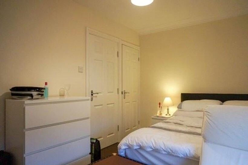 A well-maintained bedroom featuring a comfortab...