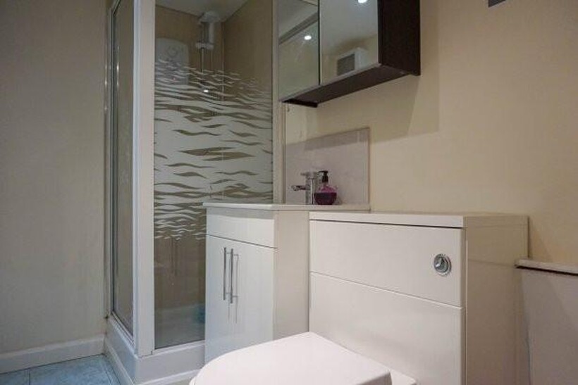 A clean and modern bathroom featuring a spaciou...