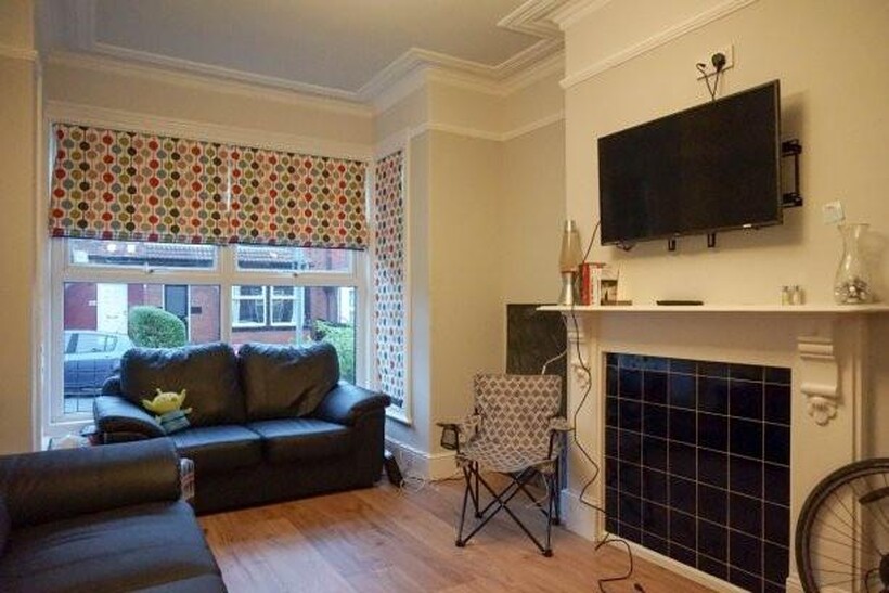 A cozy and well-maintained living room with a l...