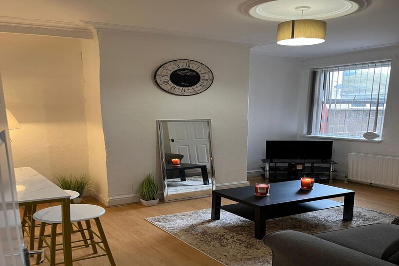 Bright and welcoming living room featuring a la...