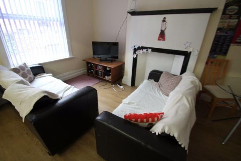 A cozy and well-maintained living room featurin...