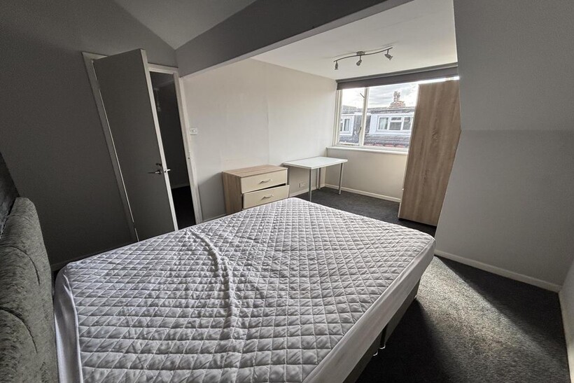 A bright and well-maintained master bedroom fea...