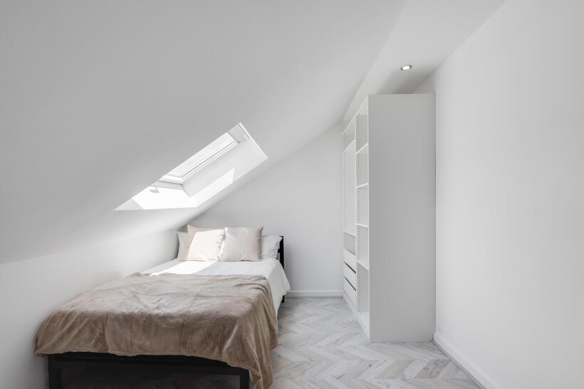 A bright, clean bedroom with a spacious feel, f...