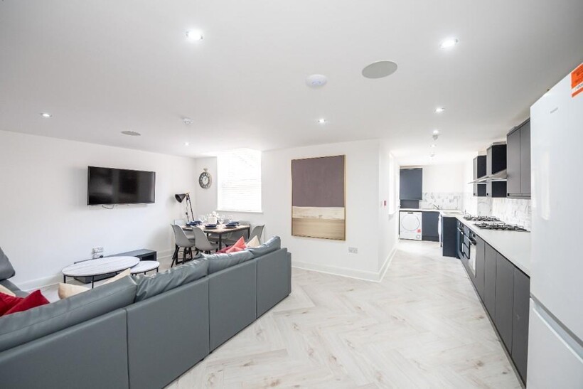 A modern, spacious living room with plenty of n...