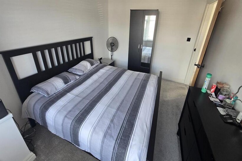 A well-maintained double bedroom featuring a co...