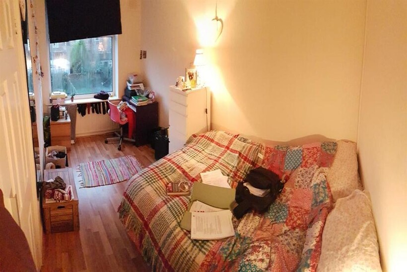 A cozy and welcoming living room featuring a pa...