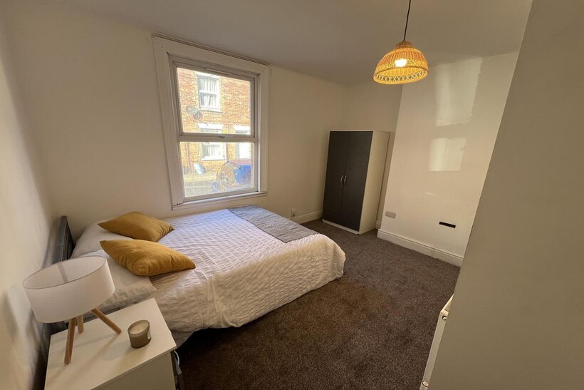 A bright and welcoming double bedroom featuring...