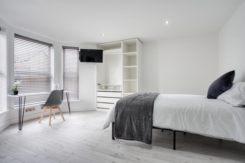 Bright and minimalist bedroom featuring a doubl...