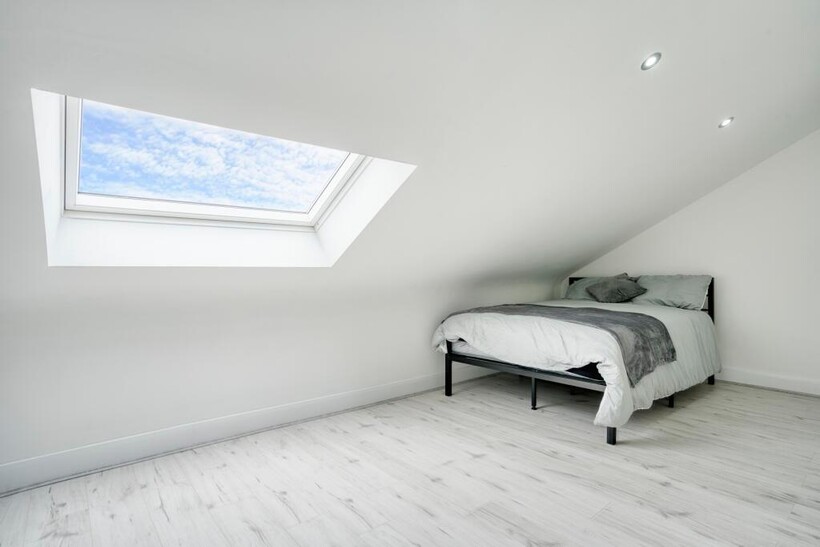 A spacious and bright master bedroom with a lar...