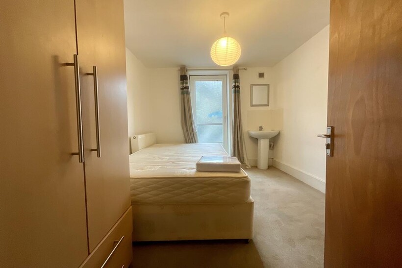 A bright, well-maintained master bedroom featur...