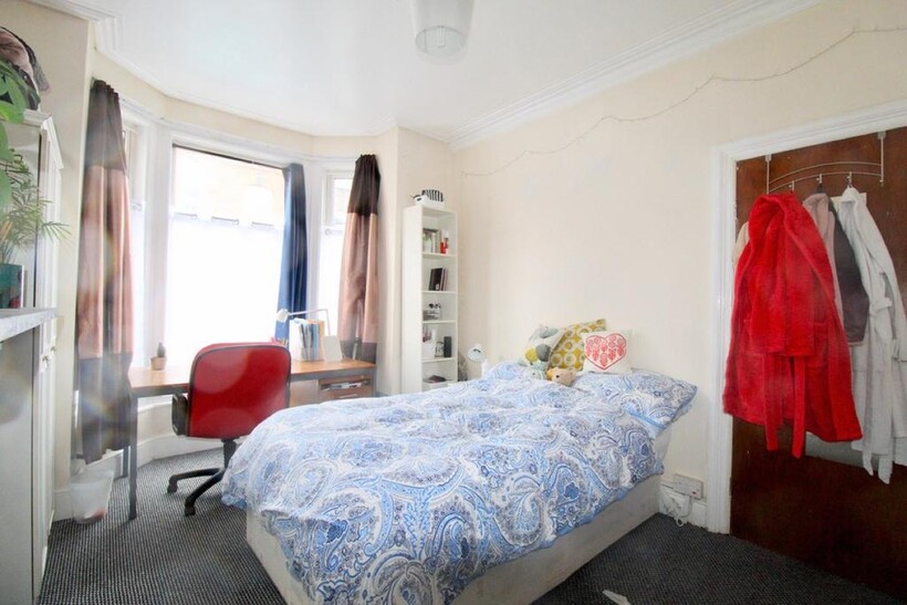 Bright and welcoming master bedroom featuring a...