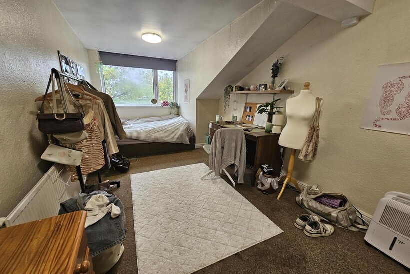 A cozy bedroom with a large window providing na...