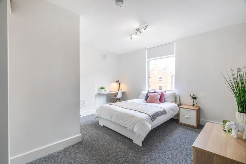 Bright and spacious master bedroom featuring a ...