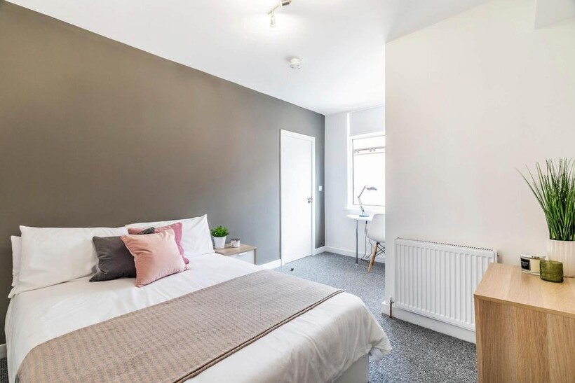 A bright and inviting double bedroom featuring ...