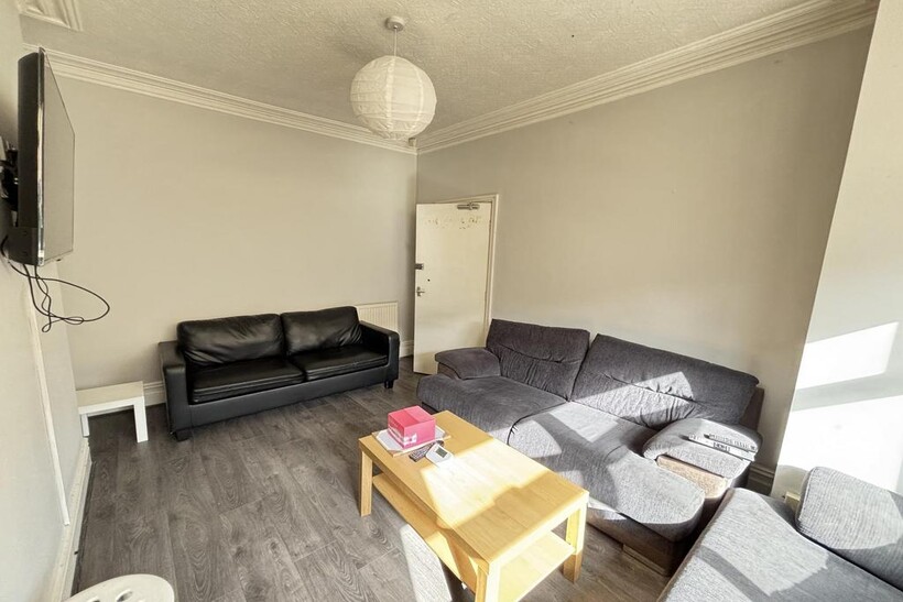 A bright, modern living room featuring comforta...