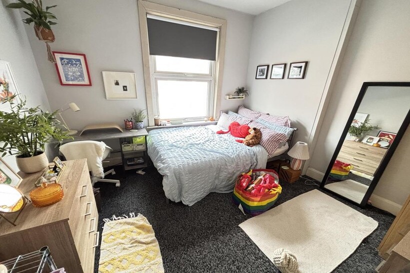 A cozy and inviting bedroom featuring a comfort...