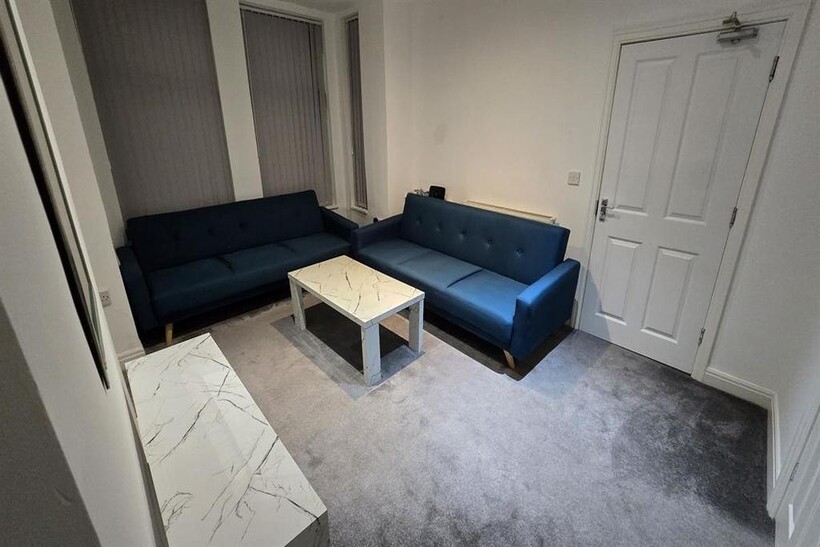 A contemporary and welcoming living room featur...