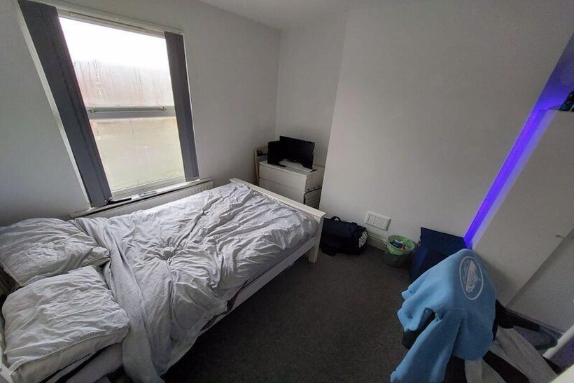 A cozy double bedroom featuring a neatly made b...