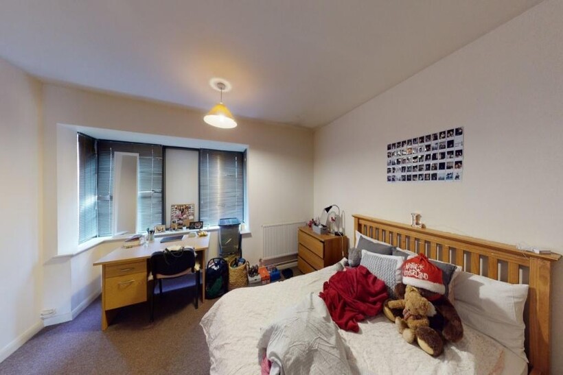 A spacious and well-lit bedroom featuring a dou...